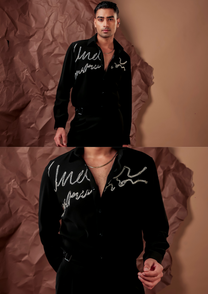 Close-up of HORD Half Baked shirt showing silver hand-beaded script on black chest and shoulder