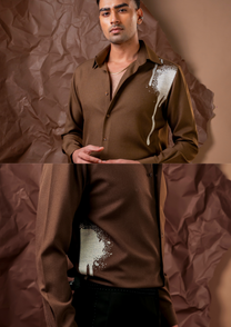 Close-up of HORD Anonymous shirt showing spray-edged sage splash and paint drip on brown