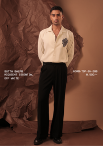 Man wearing HORD McQueentessential Off-White camp collar shirt with beaded crest, full-length studio shot