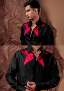 Close-up of HORD Starboy shirt showing hot pink star points framing the collar on black