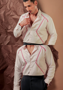 Close-up of HORD 2/7 shirt showing red zigzag hand embroidery along ivory yoke and chest