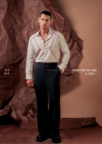 Man wearing HORD 2/7 ivory shirt with red zigzag embroidered chevron lines, full-length studio shot