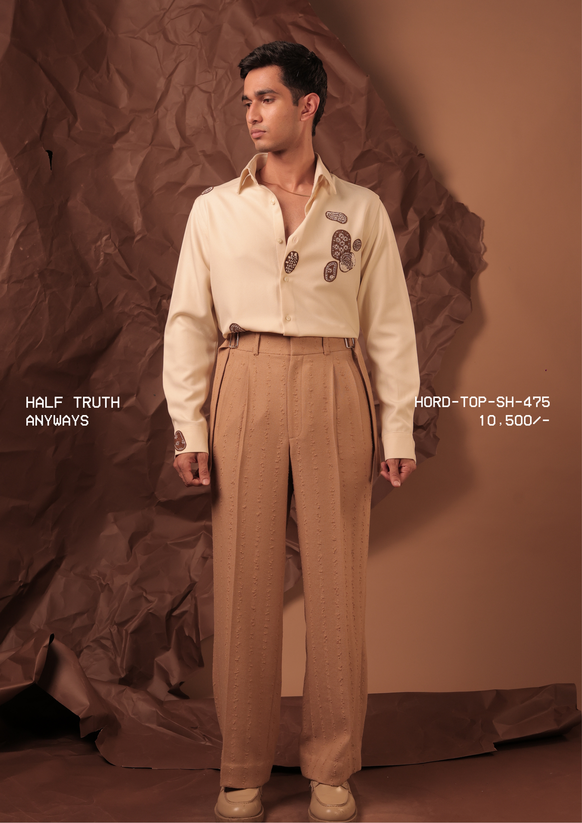 Man wearing HORD Anyways cream shirt with brown embroidered paisley motifs, styled with tan trousers