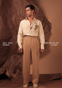 Man wearing HORD Anyways cream shirt with brown embroidered paisley motifs, styled with tan trousers