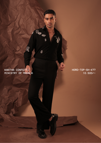 Man wearing HORD Ministry of Masala black shirt with scattered ivory beaded embroidery motifs, full-length studio shot