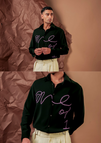 Close-up of HORD One Of 1 shirt showing lilac hand-beaded script on dark green chest