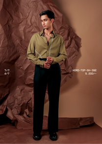 Man wearing HORD 4/7 olive shirt with ivory zigzag embroidered placket line, full-length studio shot