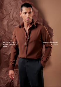 Man wearing HORD Animal Instinct brown shirt with silver embellished motifs at collar and placket, studio shot
