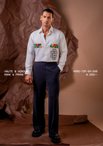 Man wearing HORD Rank and Prank off-white shirt with striped pocket bars and monogram embroidery, full-length studio shot