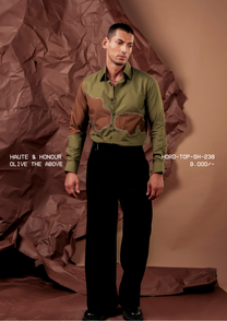 Man wearing HORD Olive The Above olive shirt with brown camo-shaped panels and beaded trim, full-length studio shot