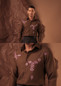Close-up of HORD Suppouse shirt showing pink and white beaded embroidery on chocolate brown