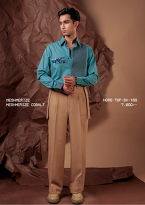 Man wearing HORD Meshmerize Panel shirt in Cobalt with check front panel and woven chest patch, styled with beige trousers