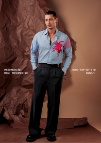 Man wearing HORD Mini Meshmerize sky blue shirt with red embroidered horseman and pink gingham sleeve panel, full-length studio shot