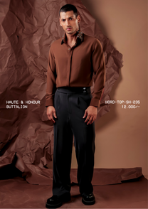 Man wearing HORD Buttalion rust shirt with black collar embellished with antique metal buttons, full-length studio shot