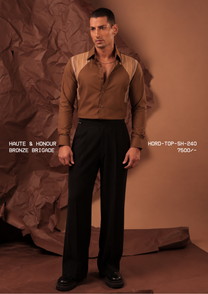 Man wearing HORD Bronze Brigade bronze shirt with striped beige raglan shoulder panels, full-length studio shot