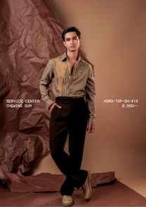 Man wearing HORD Chewing Gum khaki shirt with tan drip panel outlined in black, full-length studio shot