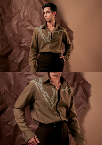 Close-up of HORD Ant Colony shirt showing ivory hand-beaded trails on olive shoulder and chest