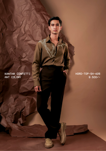 Man wearing HORD Ant Colony olive shirt with trailing ivory beaded embroidery, full-length studio shot