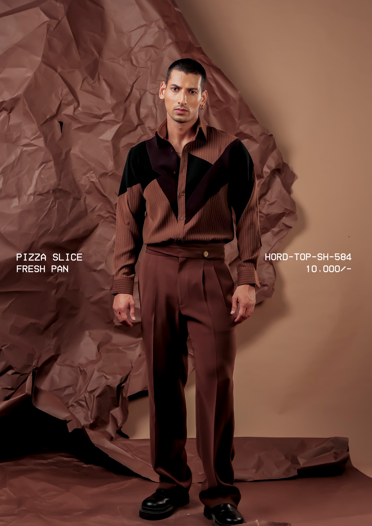 Man wearing HORD Fresh Pan brown pinstripe shirt with black chevron panels, styled as a brown co-ord, full-length studio shot