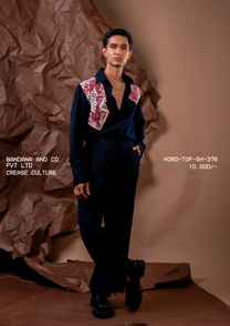 Man wearing HORD Crease Culture navy shirt with red paisley bandana shoulder panels, styled as a navy co-ord