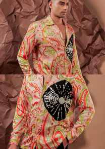 Close-up of HORD Export Quality shirt showing black fan embroidery on coral and lime paisley print