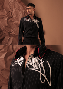 Close-up of HORD Underground AF shirt showing ivory graffiti embroidery and red-piped collar on black pinstripe