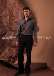 Man wearing HORD Depature Dept slate grey shirt with black diagonal straps and metal triangle hardware, full-length studio shot
