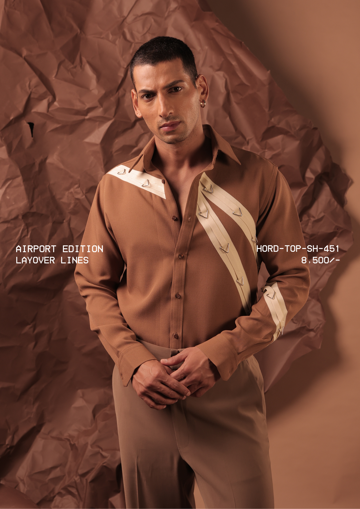 Man wearing HORD Layover Lines camel shirt with cream diagonal straps and triangle hardware, studio shot