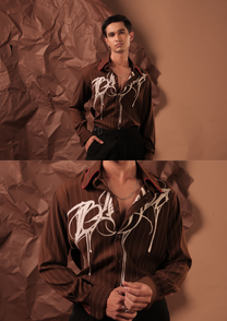 Close-up of HORD Blessed AF shirt showing ivory graffiti drips and red-piped collar on brown pinstripe