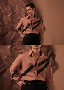 Close-up of HORD Priority Line shirt showing black straps with silver triangle rings on terracotta