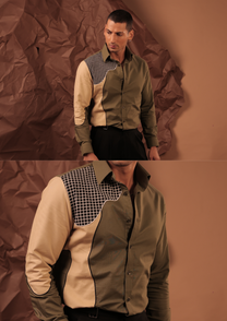 Detail of HORD Institute of Pattern Failure shirt showing curved beige sleeve panel, black piping and grid yoke on olive
