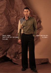 Man wearing HORD Institute of Pattern Failure olive shirt with beige side panel and grid-check yoke, full-length studio shot