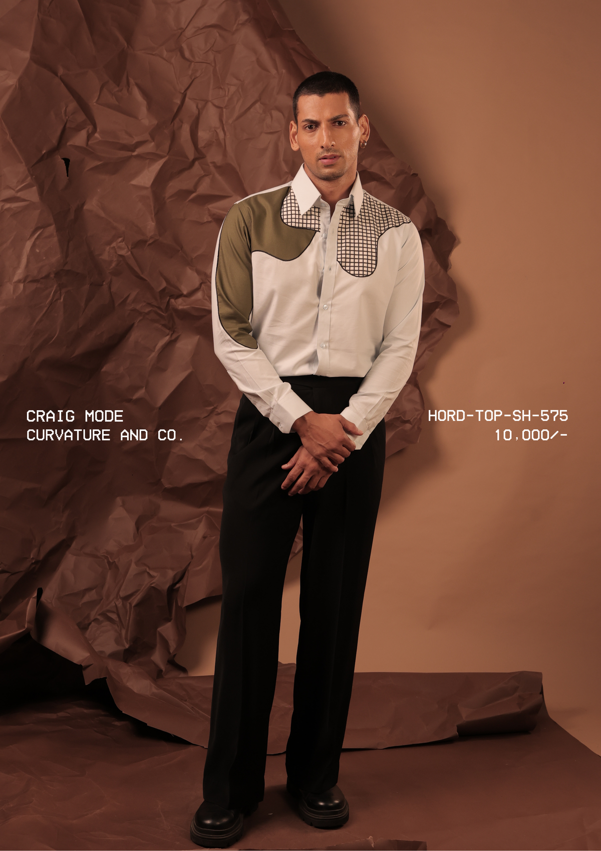 Man wearing HORD Curvature and Co. pale grey shirt with olive sleeve panel and grid-check yoke, full-length studio shot