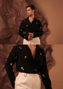 Close-up of HORD Four Corners shirt showing small multicolour pixel squares on black