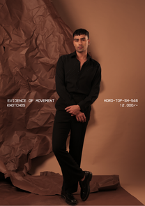 Man wearing HORD Knotchos black shirt with tonal topstitching and bead accents, full-length studio shot