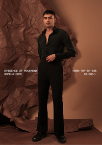 Man wearing HORD Rope-A-Dope black shirt with ivory criss-cross topstitch lines, full-length studio shot