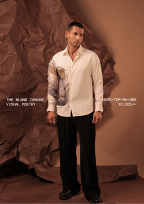 Man wearing HORD Visual Poetry ivory shirt with raw-edged blue and sand art panel on sleeve, full-length studio shot