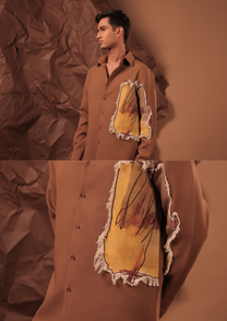 Close-up of HORD Out Of Place shirt showing frayed mustard canvas with burgundy sketch on caramel