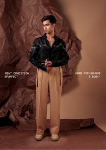 Man wearing HORD Spurfect black shirt with ivory floral embroidered western yoke, styled with tan trousers