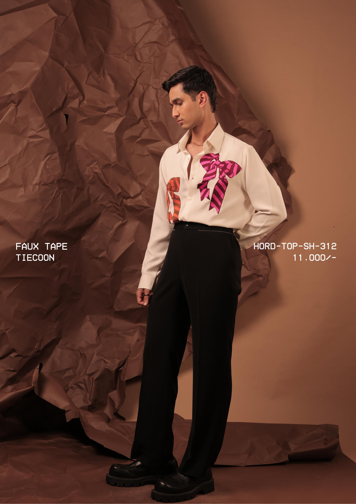 Man wearing HORD Tiecoon ivory shirt with oversized rust and magenta striped bow motifs, full-length studio shot